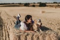 Young beautiful woman walking with her golden retriever dog on a yellow field at sunset. Nature and lifestyle outdoors Royalty Free Stock Photo