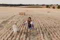 Young beautiful woman walking with her golden retriever dog on a yellow field at sunset. Nature and lifestyle outdoors. Funny dog Royalty Free Stock Photo