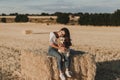 Young beautiful woman walking with her golden retriever dog on a yellow field at sunset. Nature and lifestyle outdoors Royalty Free Stock Photo