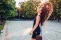 Young beautiful woman walking in summer park. Stylish lady throwing her long healthy hair Royalty Free Stock Photo