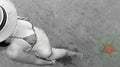 Young beautiful woman watching a starfish in the water of Playa Estrella in Colon Island, Bocas del Toro, Panama Royalty Free Stock Photo