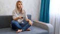 Young beautiful woman watching TV on couch at living room surprised and excited Royalty Free Stock Photo