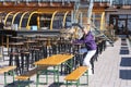 Young beautiful woman wear sitting in outdoor restaurant. Skiing resort in Alps.