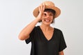 Young beautiful woman wearing black t-shirt and hat standing over isolated white background with happy face smiling doing ok sign Royalty Free Stock Photo