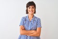 Young beautiful woman wearing blue striped shirt standing over isolated white background happy face smiling with crossed arms Royalty Free Stock Photo