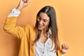 Young beautiful woman wearing business style and glasses dancing happy and cheerful, smiling moving casual and confident listening Royalty Free Stock Photo