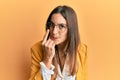 Young beautiful woman wearing business style and glasses pointing to the eye watching you gesture, suspicious expression Royalty Free Stock Photo