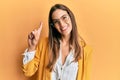 Young beautiful woman wearing business style and glasses showing and pointing up with finger number one while smiling confident Royalty Free Stock Photo