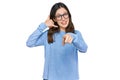 Young beautiful woman wearing casual clothes and glasses smiling doing talking on the telephone gesture and pointing to you Royalty Free Stock Photo