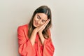 Young beautiful woman wearing casual clothes sleeping tired dreaming and posing with hands together while smiling with closed eyes Royalty Free Stock Photo