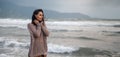 Woman wearing casual clothing enjoying sea storm and water waves of the sea on the beach Royalty Free Stock Photo