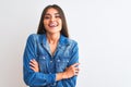 Young beautiful woman wearing casual denim shirt standing over isolated white background happy face smiling with crossed arms Royalty Free Stock Photo