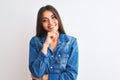 Young beautiful woman wearing casual denim shirt standing over isolated white background looking confident at the camera smiling Royalty Free Stock Photo