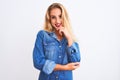 Young beautiful woman wearing casual denim shirt standing over isolated white background looking confident at the camera smiling Royalty Free Stock Photo