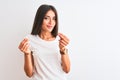 Young beautiful woman wearing casual t-shirt standing over isolated white background doing money gesture with hands, asking for Royalty Free Stock Photo