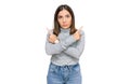 Young beautiful woman wearing casual turtleneck sweater pointing to both sides with fingers, different direction disagree Royalty Free Stock Photo