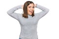 Young beautiful woman wearing casual turtleneck sweater relaxing and stretching, arms and hands behind head and neck smiling happy Royalty Free Stock Photo