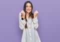 Young beautiful woman wearing casual white shirt excited for success with arms raised and eyes closed celebrating victory smiling Royalty Free Stock Photo