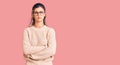 Young beautiful woman wearing casual winter sweater and glasses skeptic and nervous, disapproving expression on face with crossed Royalty Free Stock Photo