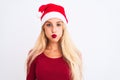 Young beautiful woman wearing Christmas Santa hat over isolated white background puffing cheeks with funny face Royalty Free Stock Photo