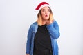 Young beautiful woman wearing Christmas Santa hat standing over isolated white background looking at the camera blowing a kiss Royalty Free Stock Photo