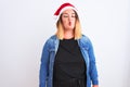 Young beautiful woman wearing Christmas Santa hat standing over  white background making fish face with lips, crazy and Royalty Free Stock Photo