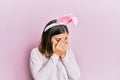 Young beautiful woman wearing cute easter bunny ears with sad expression covering face with hands while crying Royalty Free Stock Photo