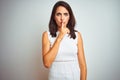 Young beautiful woman wearing dress standing over white isolated background asking to be quiet with finger on lips Royalty Free Stock Photo