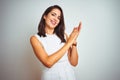 Young beautiful woman wearing dress standing over white isolated background clapping and applauding happy and joyful, smiling Royalty Free Stock Photo