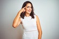 Young beautiful woman wearing dress standing over white isolated background Smiling pointing to head with one finger, great idea Royalty Free Stock Photo