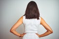 Young beautiful woman wearing dress standing over white isolated background standing backwards looking away with arms on body Royalty Free Stock Photo