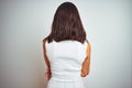 Young beautiful woman wearing dress standing over white isolated background standing backwards looking away with crossed arms Royalty Free Stock Photo