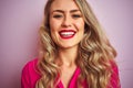 Young beautiful woman wearing elegant shirt standing over pink isolated background with a happy face standing and smiling with a Royalty Free Stock Photo