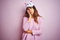 Young beautiful woman wearing funny cat cap standing over pink isolated background thinking looking tired and bored with Royalty Free Stock Photo