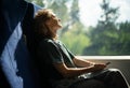 Young beautiful woman wearing glasses sitting in a chair in a high-speed train relaxing while traveling Royalty Free Stock Photo