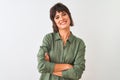 Young beautiful woman wearing green casual shirt standing over isolated white background happy face smiling with crossed arms Royalty Free Stock Photo