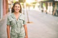 Young beautiful woman wearing green dress standing on the streets smiling Royalty Free Stock Photo