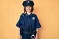 Young beautiful woman wearing police uniform with a happy and cool smile on face Royalty Free Stock Photo