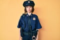 Young beautiful woman wearing police uniform puffing cheeks with funny face Royalty Free Stock Photo