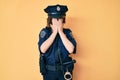 Young beautiful woman wearing police uniform with sad expression covering face with hands while crying Royalty Free Stock Photo