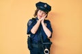 Young beautiful woman wearing police uniform sleeping tired dreaming and posing with hands together while smiling with closed eyes Royalty Free Stock Photo