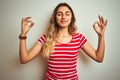 Young beautiful woman wearing red stripes t-shirt over white isolated background relax and smiling with eyes closed doing Royalty Free Stock Photo