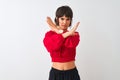 Young beautiful woman wearing red summer t-shirt standing over isolated white background Rejection expression crossing arms doing Royalty Free Stock Photo