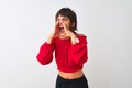 Young beautiful woman wearing red summer t-shirt standing over isolated white background Shouting angry out loud with hands over Royalty Free Stock Photo