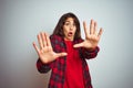 Young beautiful woman wearing red t-shirt and jacket standing over white isolated background afraid and terrified with fear Royalty Free Stock Photo