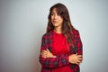 Young beautiful woman wearing red t-shirt and jacket standing over white isolated background smiling looking to the side and Royalty Free Stock Photo