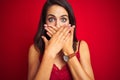 Young beautiful woman wearing sexy lingerie over red isolated background shocked covering mouth with hands for mistake Royalty Free Stock Photo