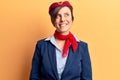 Young beautiful woman wearing stewardess uniform looking away to side with smile on face, natural expression