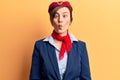 Young beautiful woman wearing stewardess uniform making fish face with lips, crazy and comical gesture