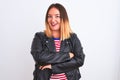 Young beautiful woman wearing striped shirt and jacket over isolated white background happy face smiling with crossed arms looking Royalty Free Stock Photo